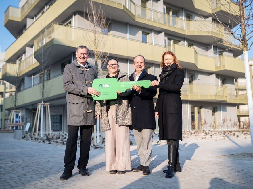 Hirschfeld Schlüsselübergabe - Bezirksvorsteher Georg Papai (links) und ARE Projektentwicklungsleiterin Michaela Koban (rechts) mit ersten Bewohner*innen